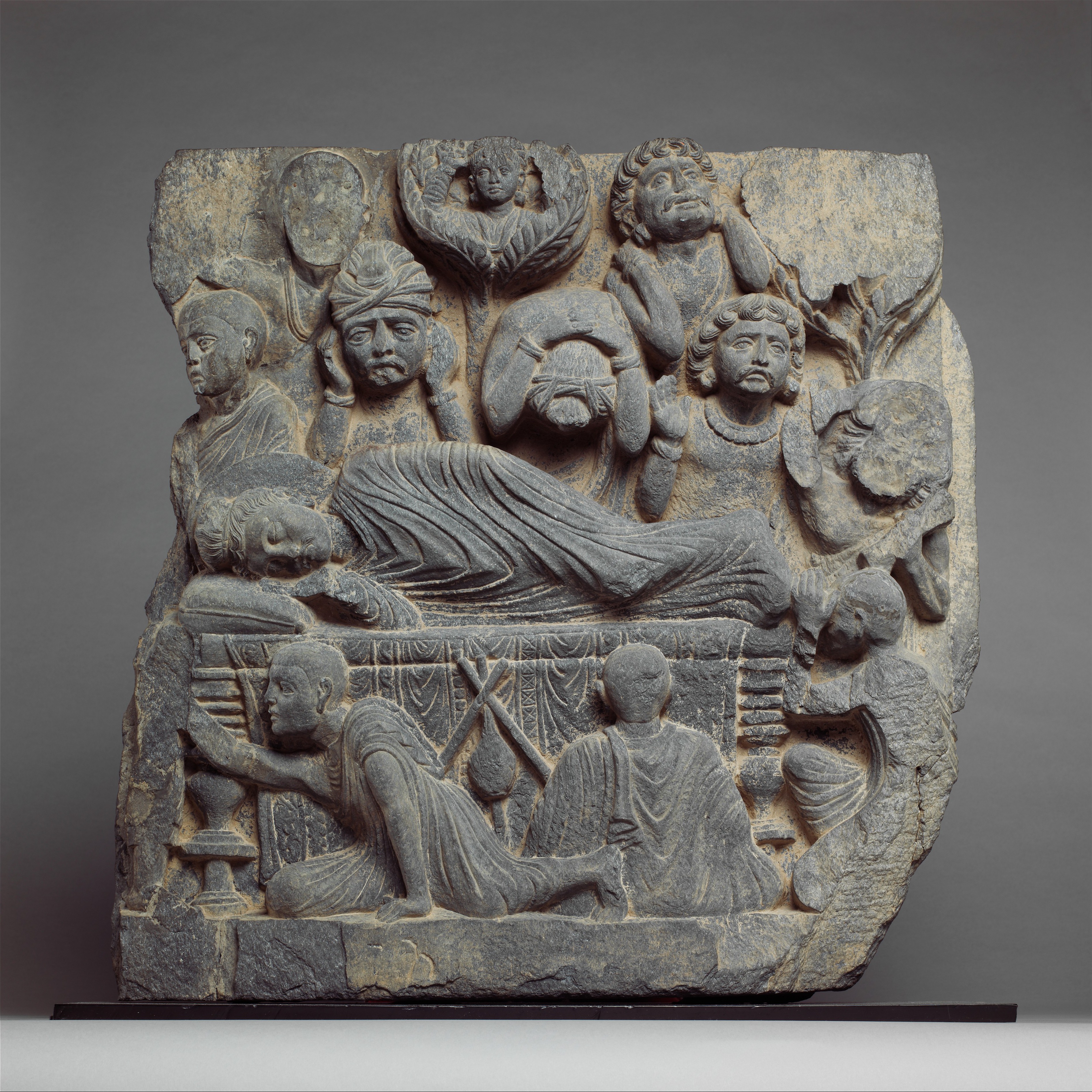 Gandhara parinirvana relief—Greco-Buddhist art from the crossroads of Zoroastrian, Buddhist, and Hellenistic traditions